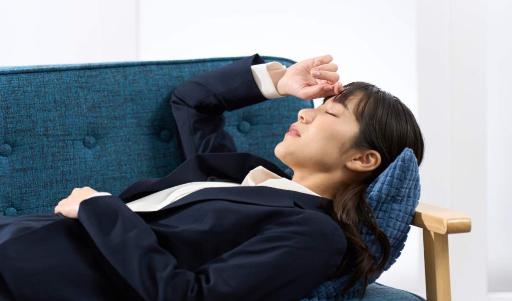 A woman lying on the sofa tired from work