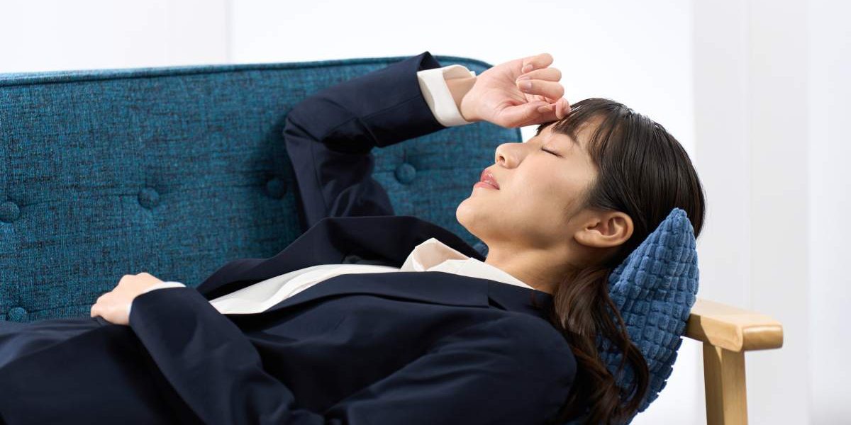 A woman lying on the sofa tired from work