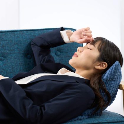 A woman lying on the sofa tired from work