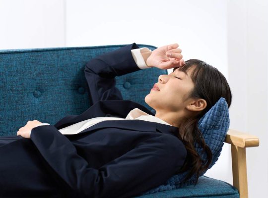 A woman lying on the sofa tired from work