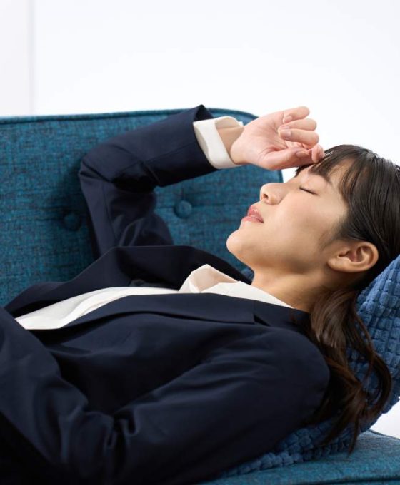 A woman lying on the sofa tired from work