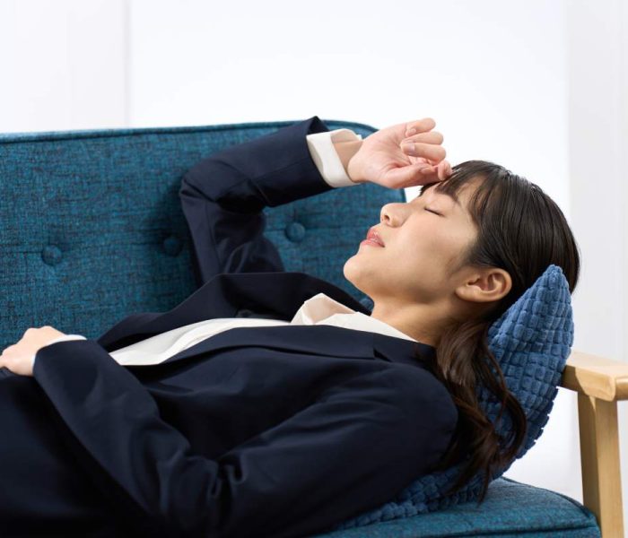 A woman lying on the sofa tired from work